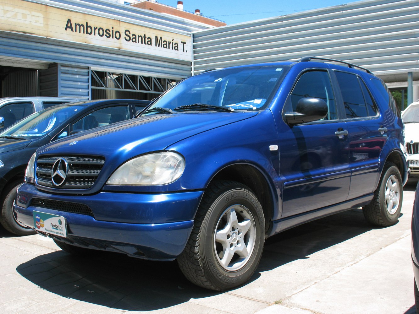 Blue SUV with five-spoke alloy wheels and roof rails