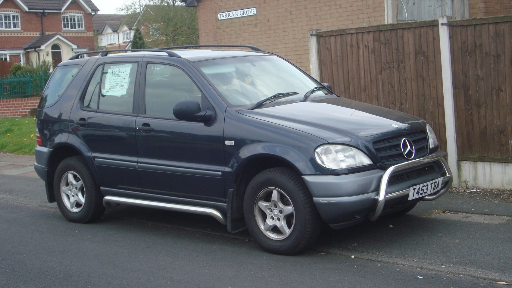 SUV with bull bar, roof rails, alloy wheels, five-door body