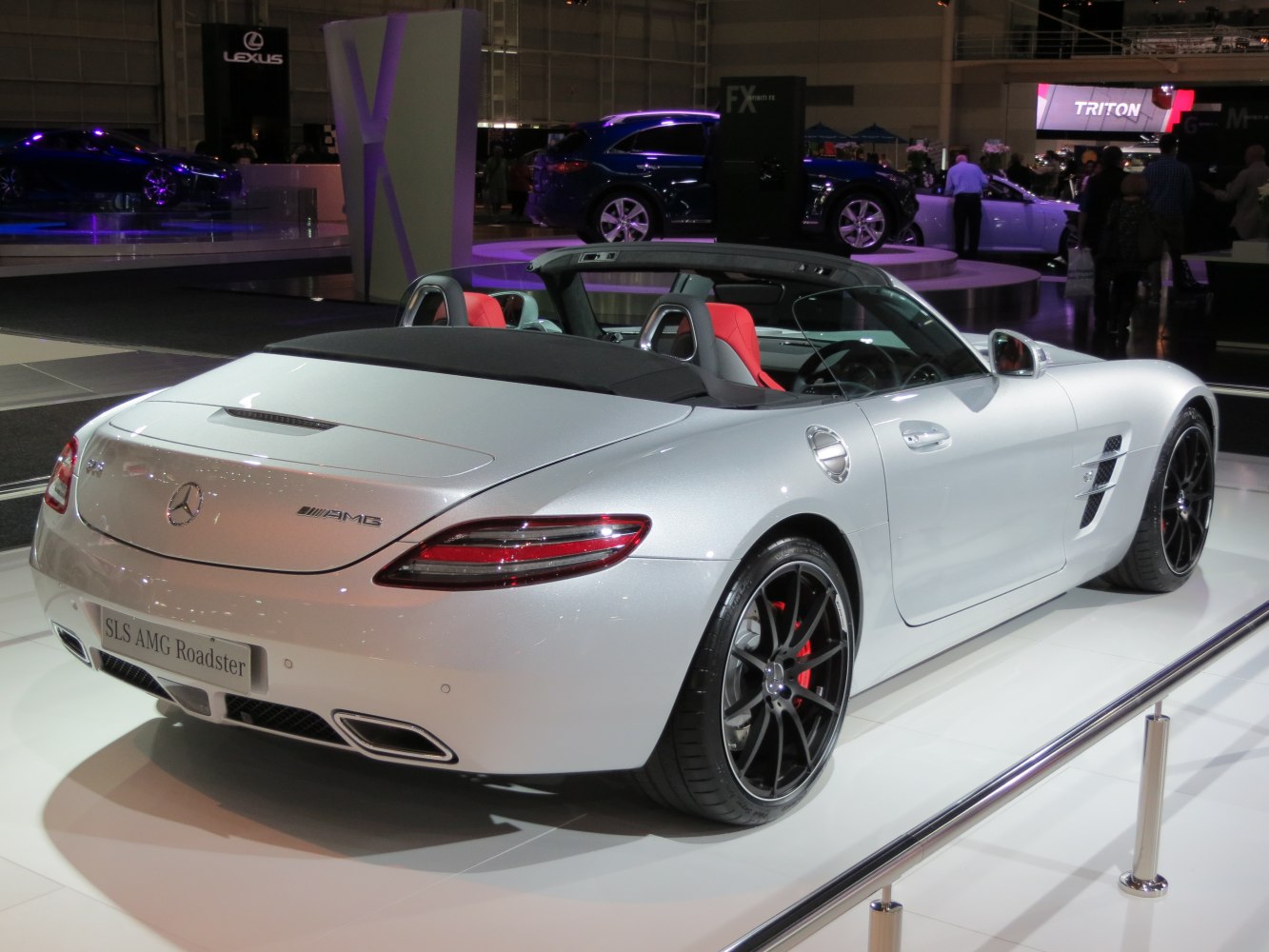 Rear view of a convertible with black alloy wheels and red seats.