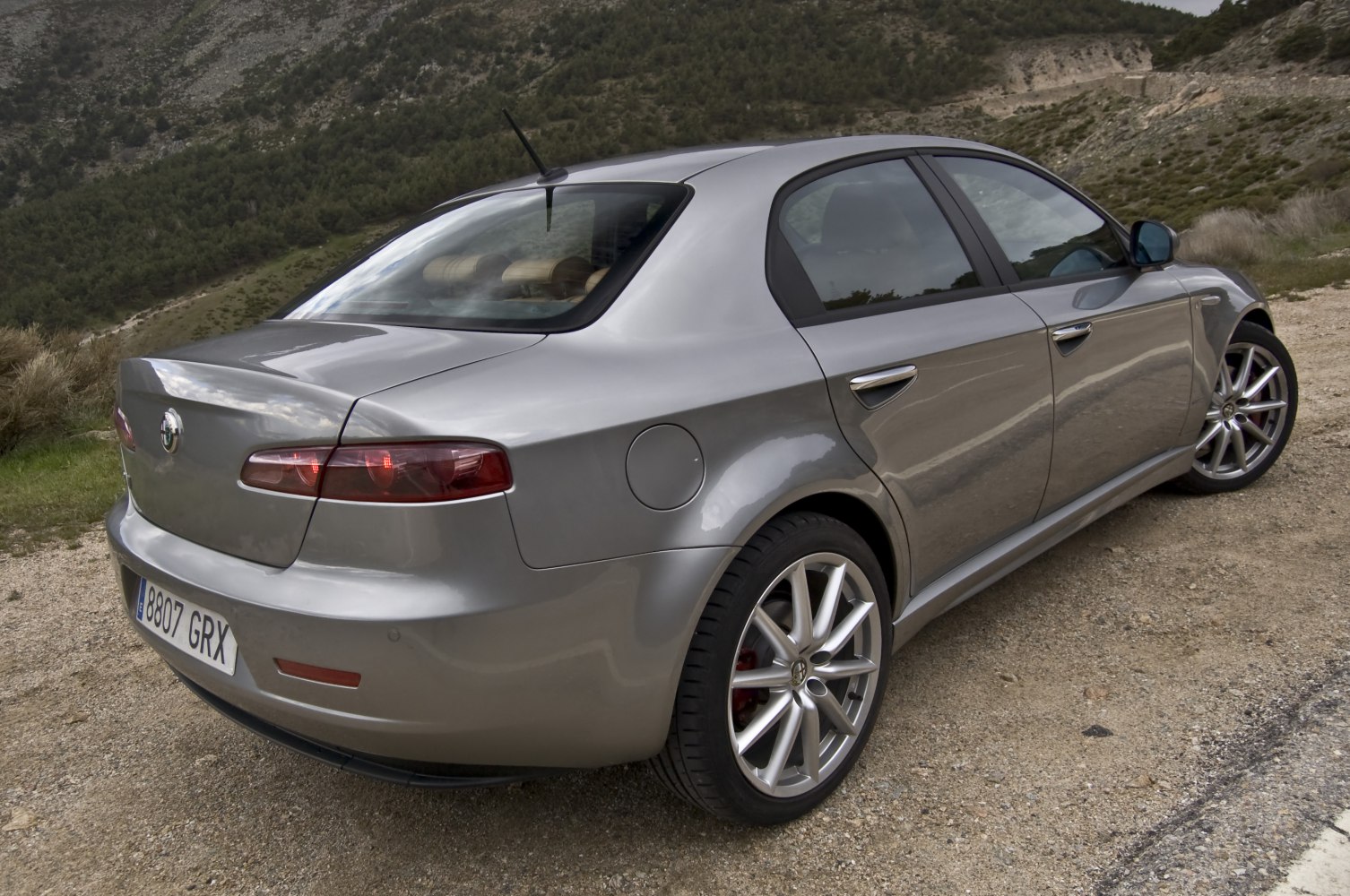 Rear and side perspective of a sedan with alloy wheels and smooth body lines