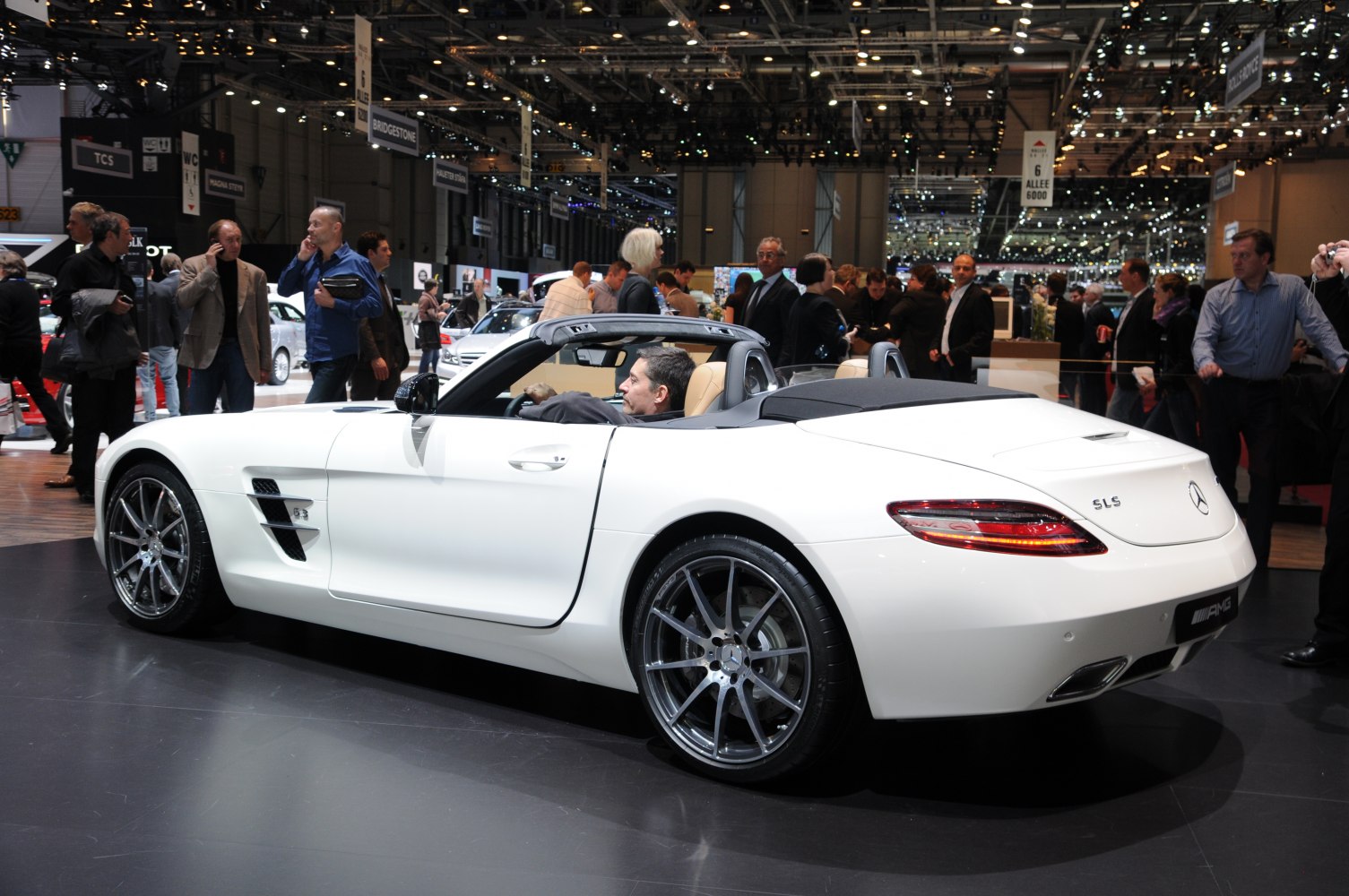 White convertible roadster with sporty wheels and aerodynamic design.