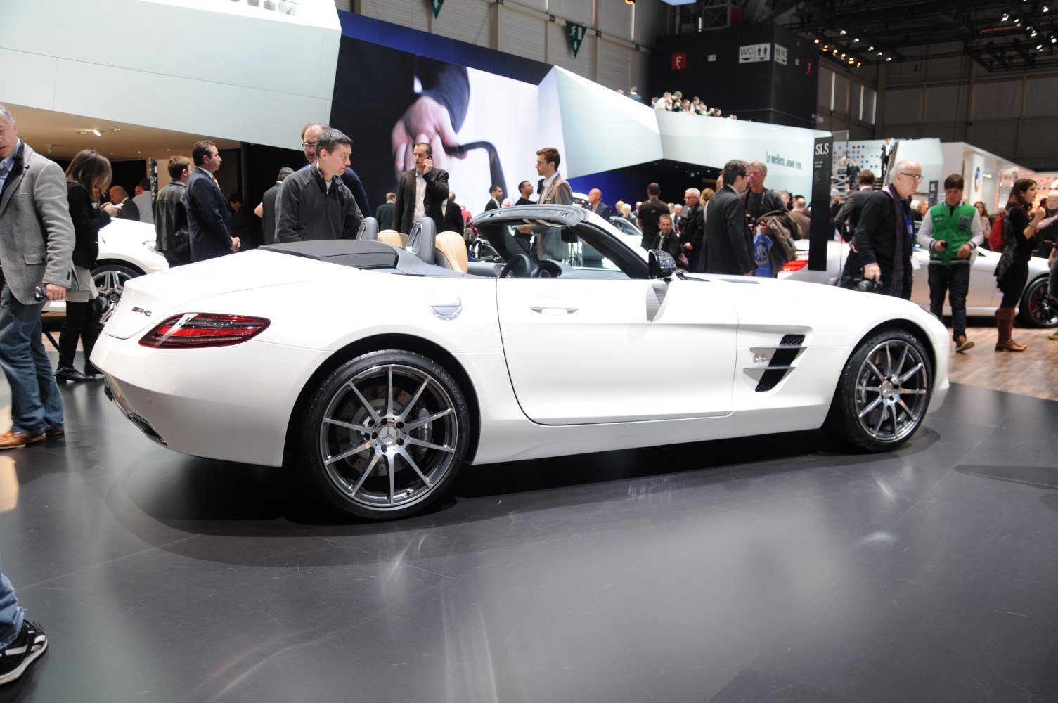 White convertible sports car side profile with alloy wheels