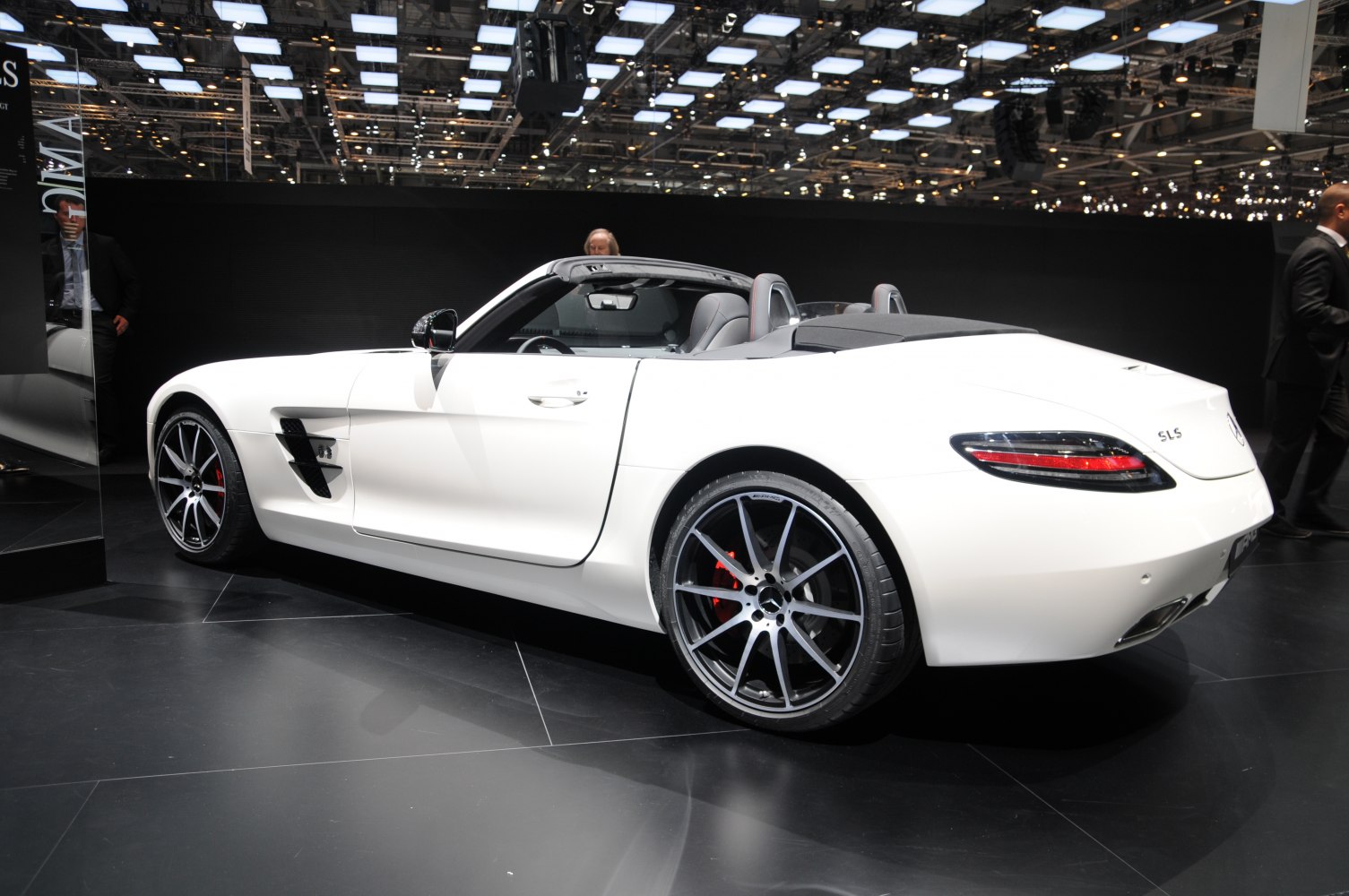 Rear side view of white convertible with large alloy wheels