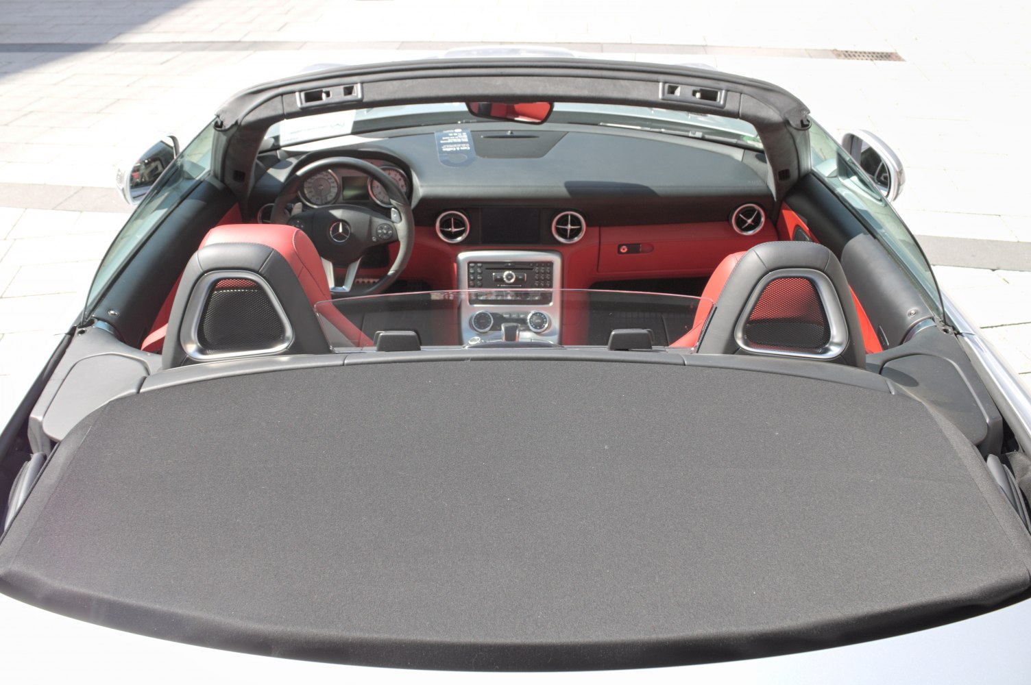 Convertible car interior with red and black seats and dashboard