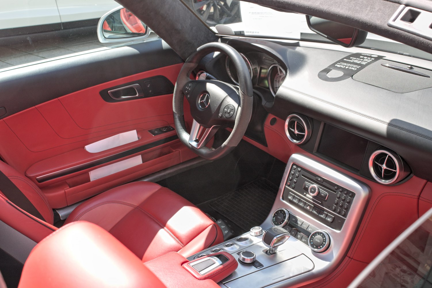 Sporty car interior with red leather seats and advanced dashboard controls
