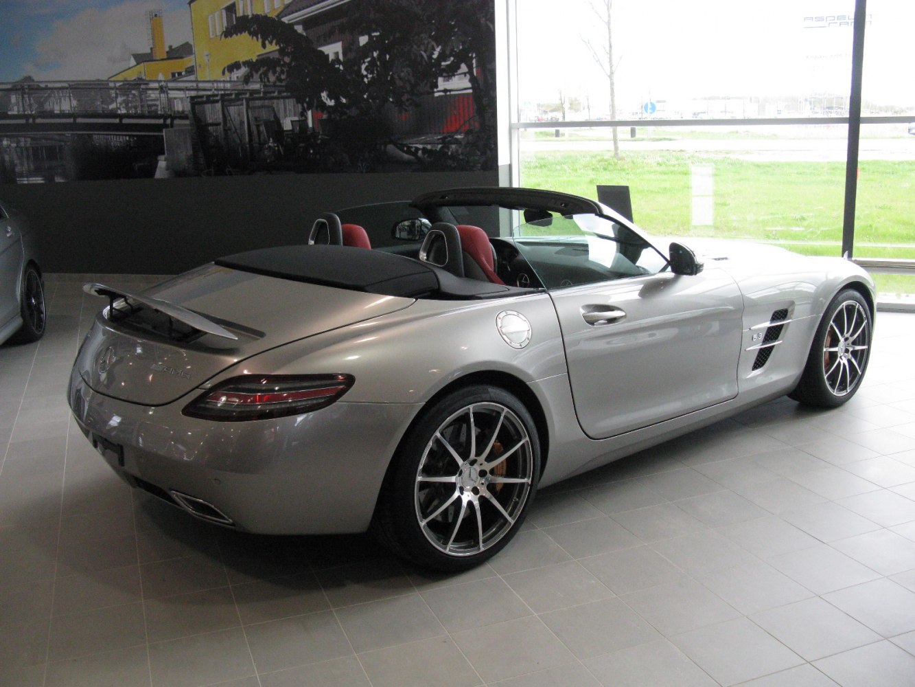 Convertible sports car rear with soft top and spoiler