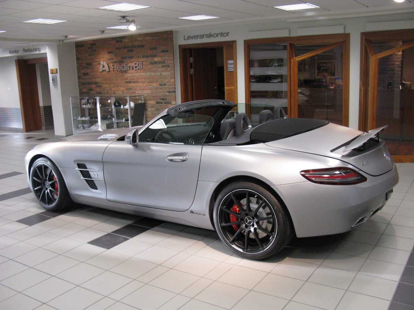 Convertible sports car with active rear spoiler and black alloy wheels