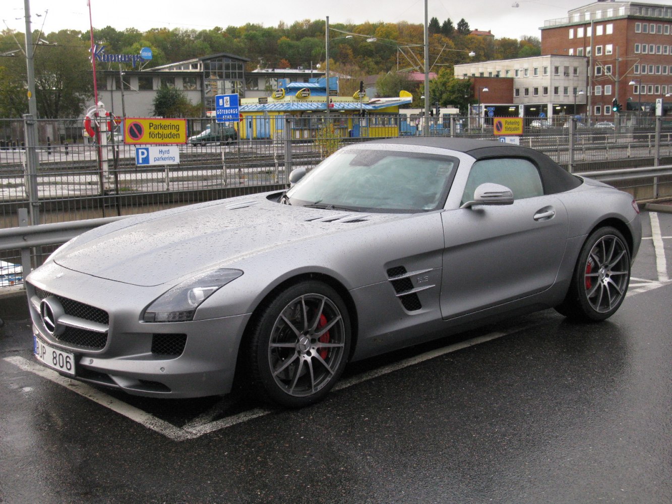 Silver convertible roadster with sporty vents and alloy wheels.