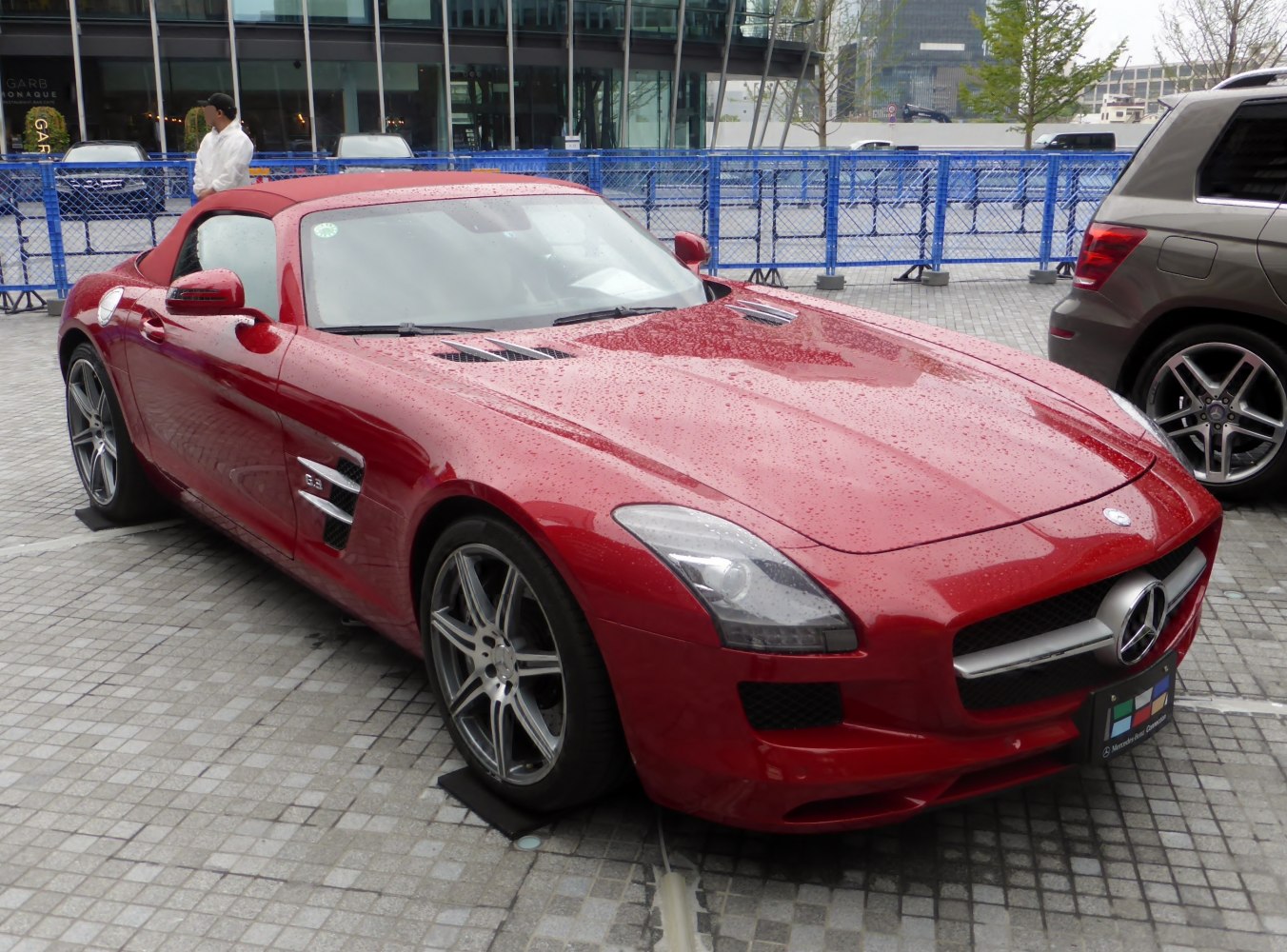Red convertible roadster with front grille and hood vents
