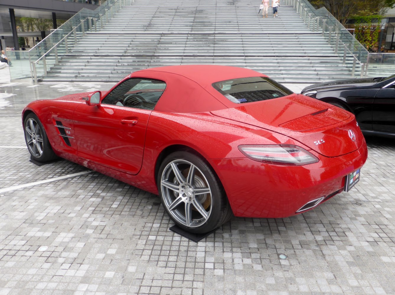 Red convertible sports car with soft top and alloy wheels