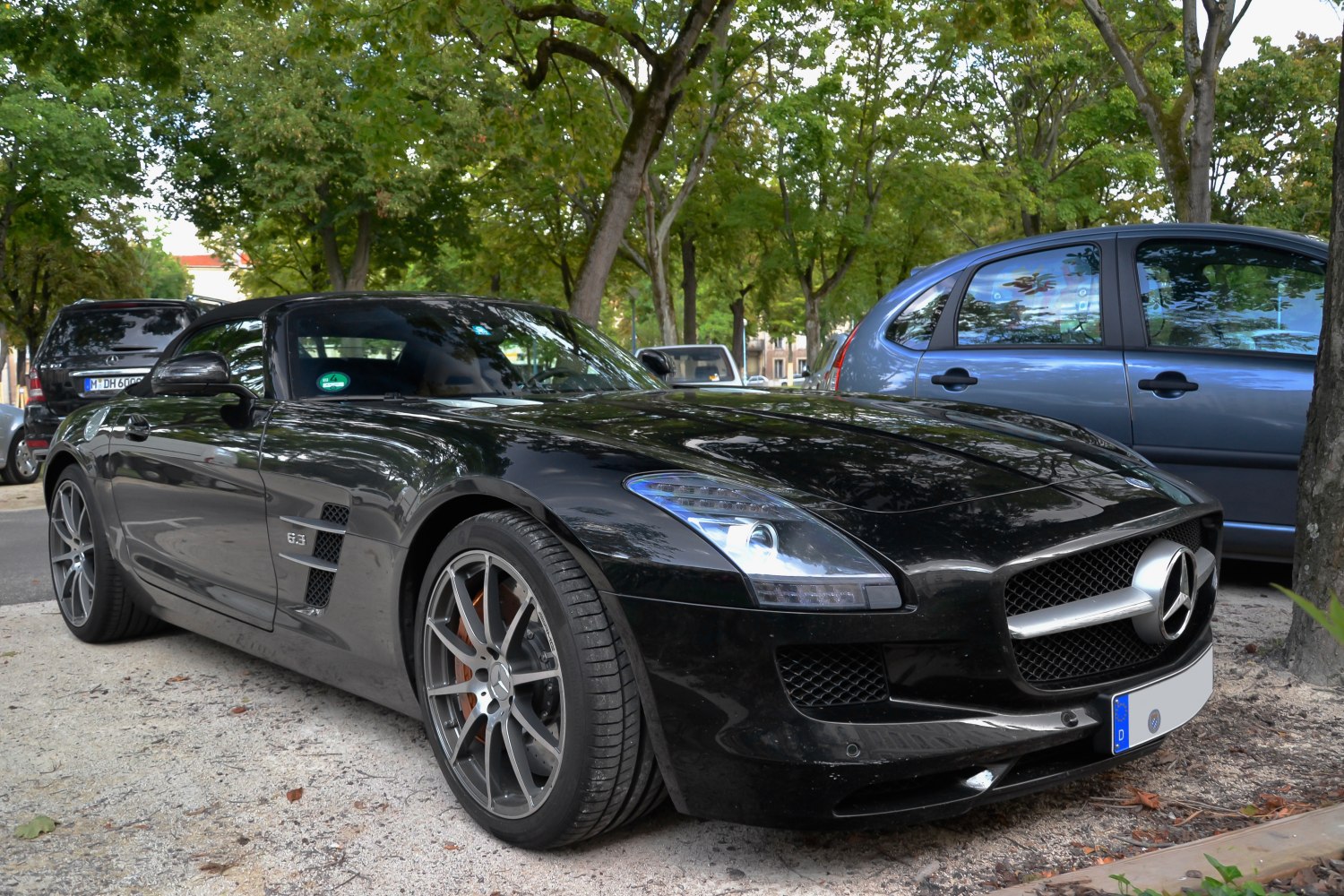 Front side view of black convertible with 6.3 badge and distinctive grille