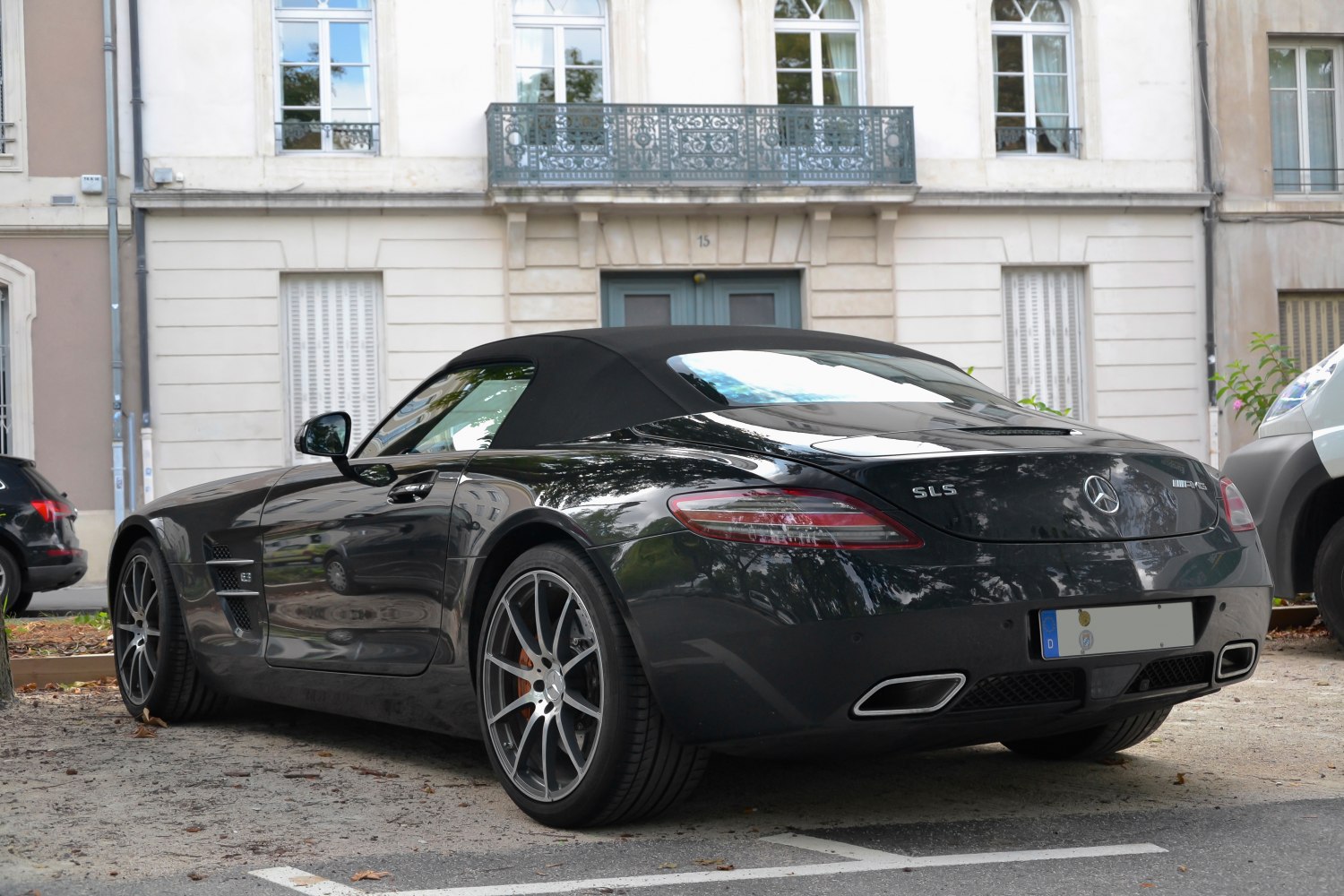 Rear view of convertible sports vehicle with soft top and dual exhausts