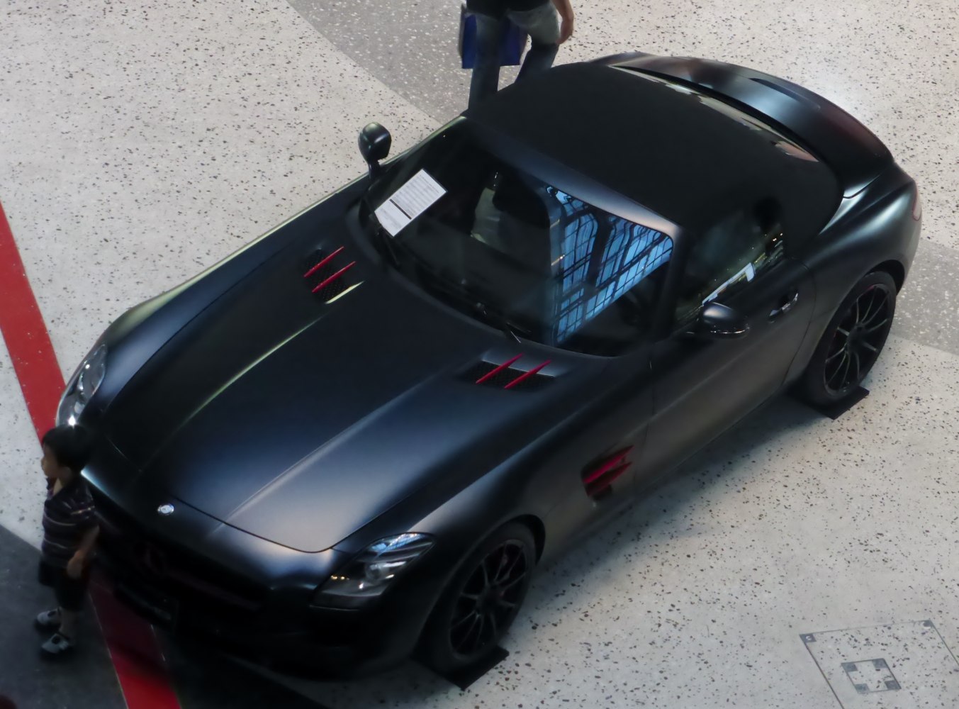 Matte black roadster with sporty vented hood and aerodynamic design