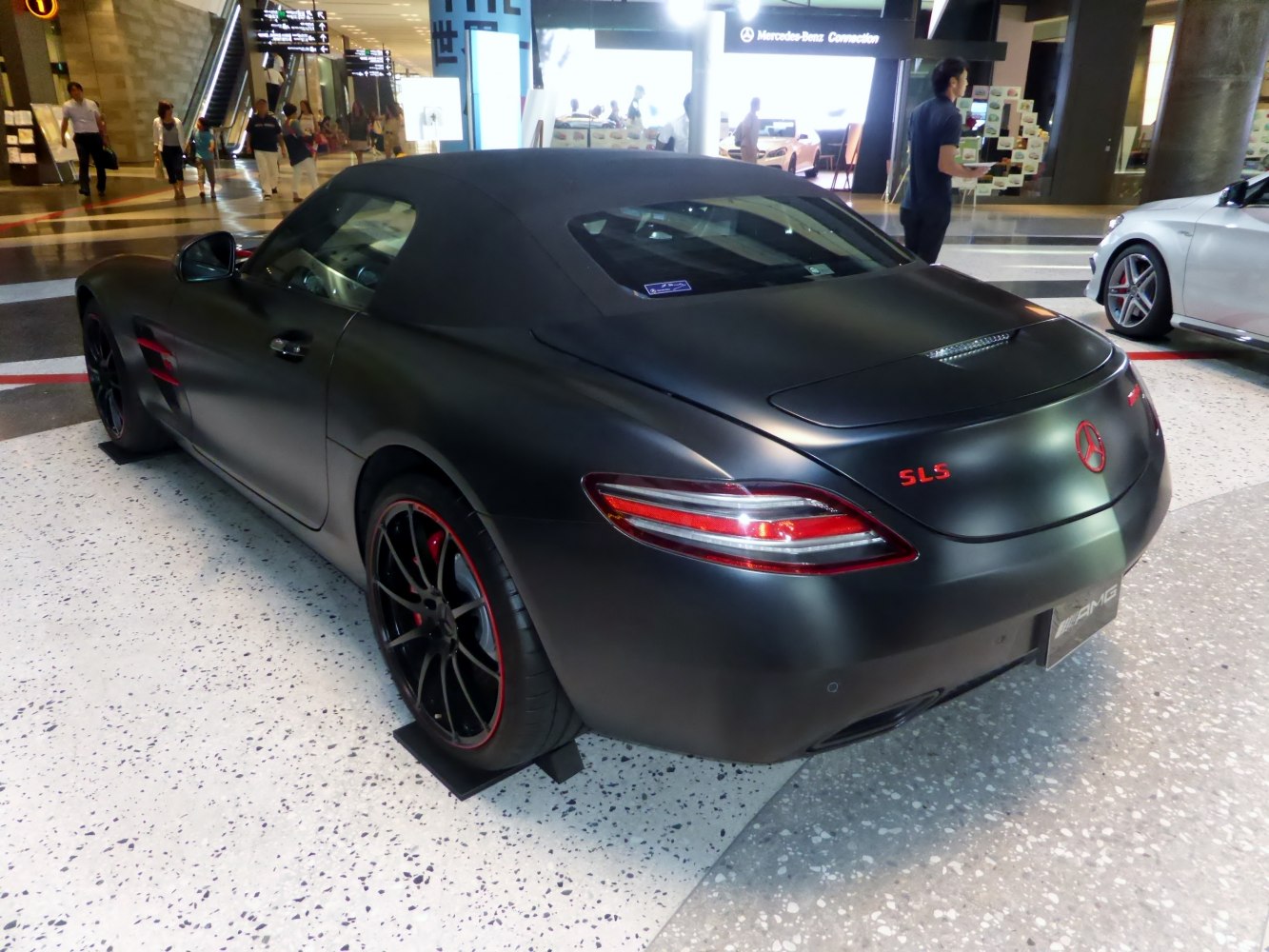 Matte black roadster rear with LED taillights and red-highlighted rims