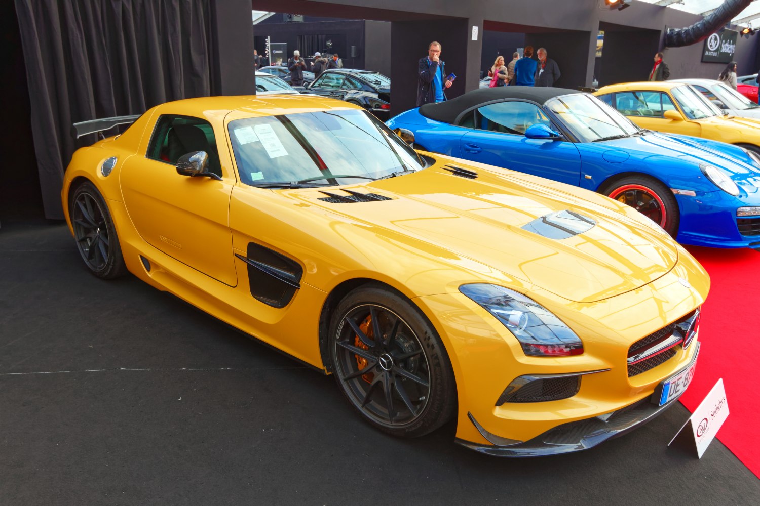 Yellow sports coupe with black alloy wheels and dynamic aerodynamic vents