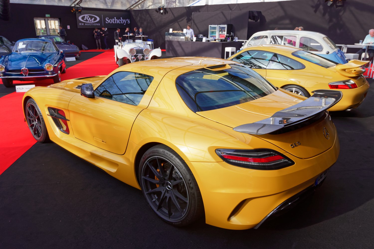 Yellow sports car with carbon fiber rear wing and dark sporty wheels