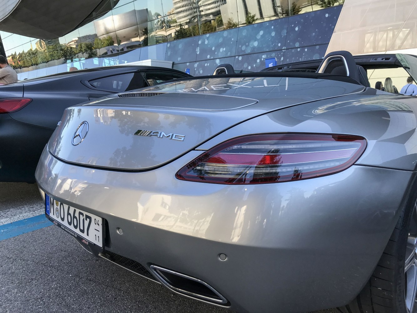 Rear end with AMG badge and sleek tail light of a luxury roadster