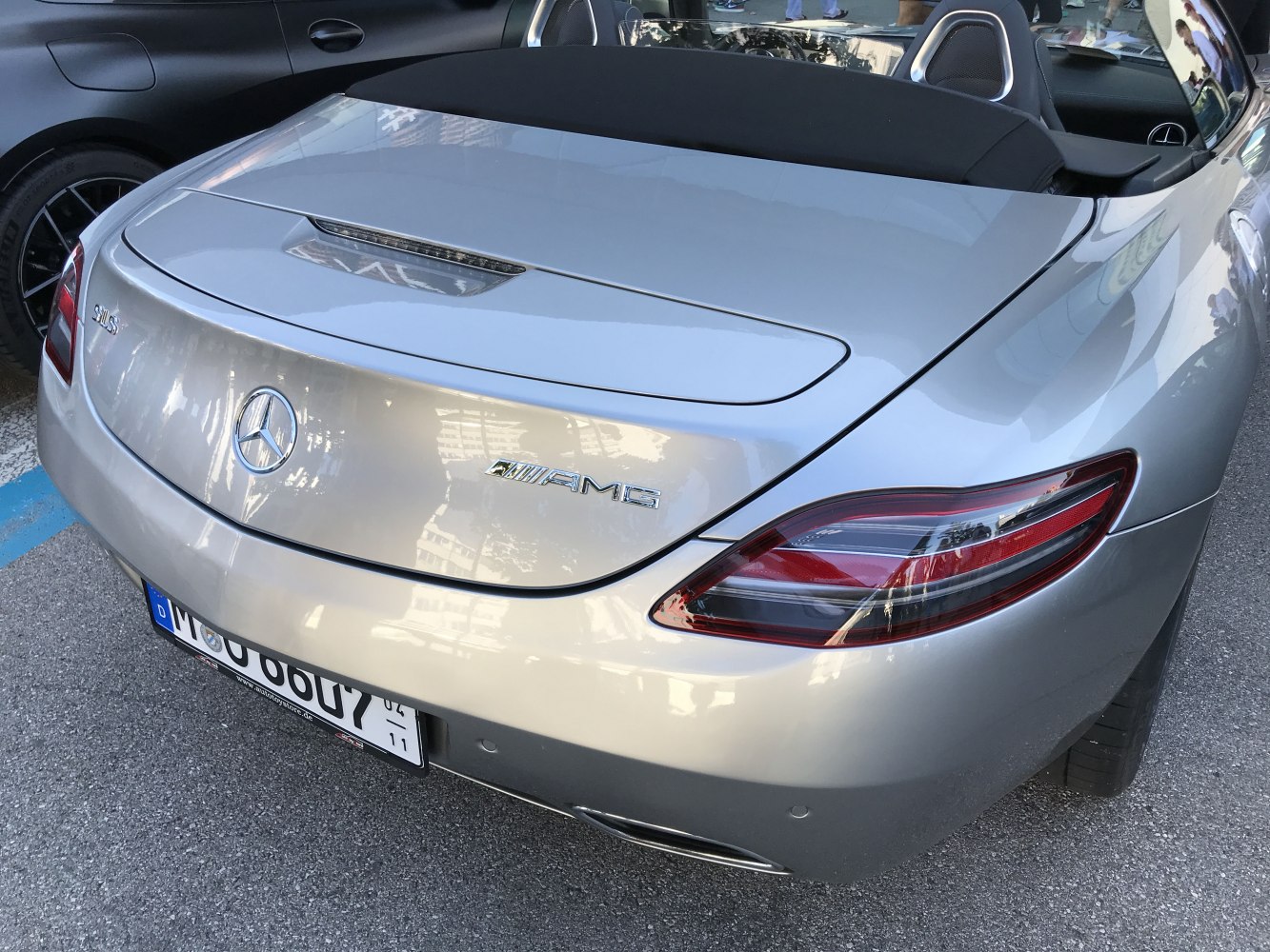 Luxury roadster rear end with AMG badge and sleek tail lights