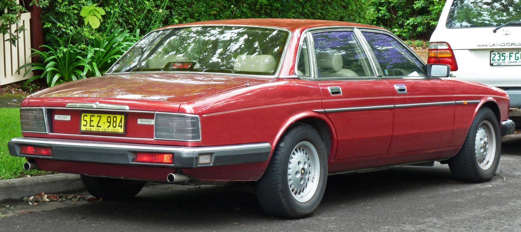 Rear view of classic luxury sedan with rectangular taillights and dual exhaust pipes