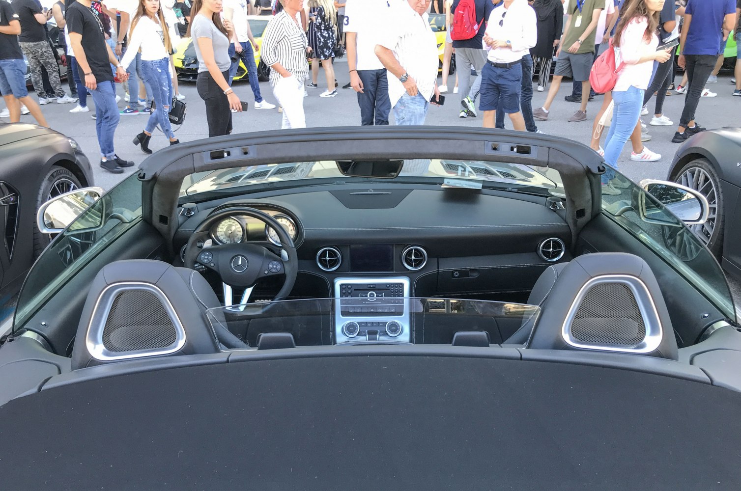 Convertible interior with dashboard, steering wheel, and headrest design