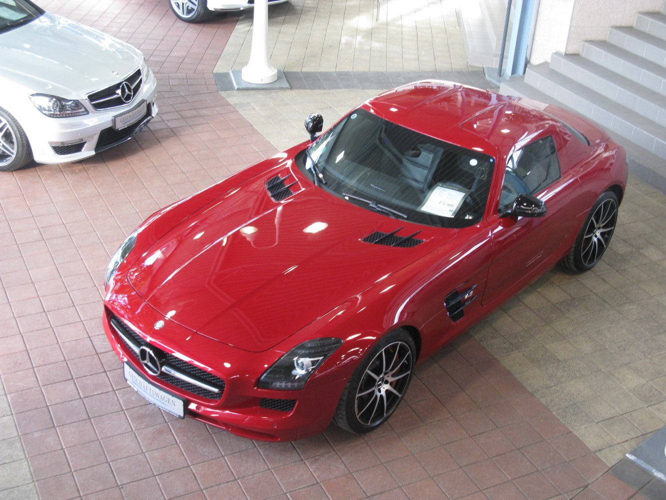 Red luxury coupe with gullwing doors and sporty aerodynamic design