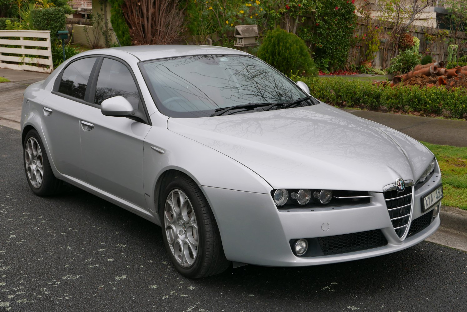 Silver sedan with triangular grille and multi-spoke alloy wheels