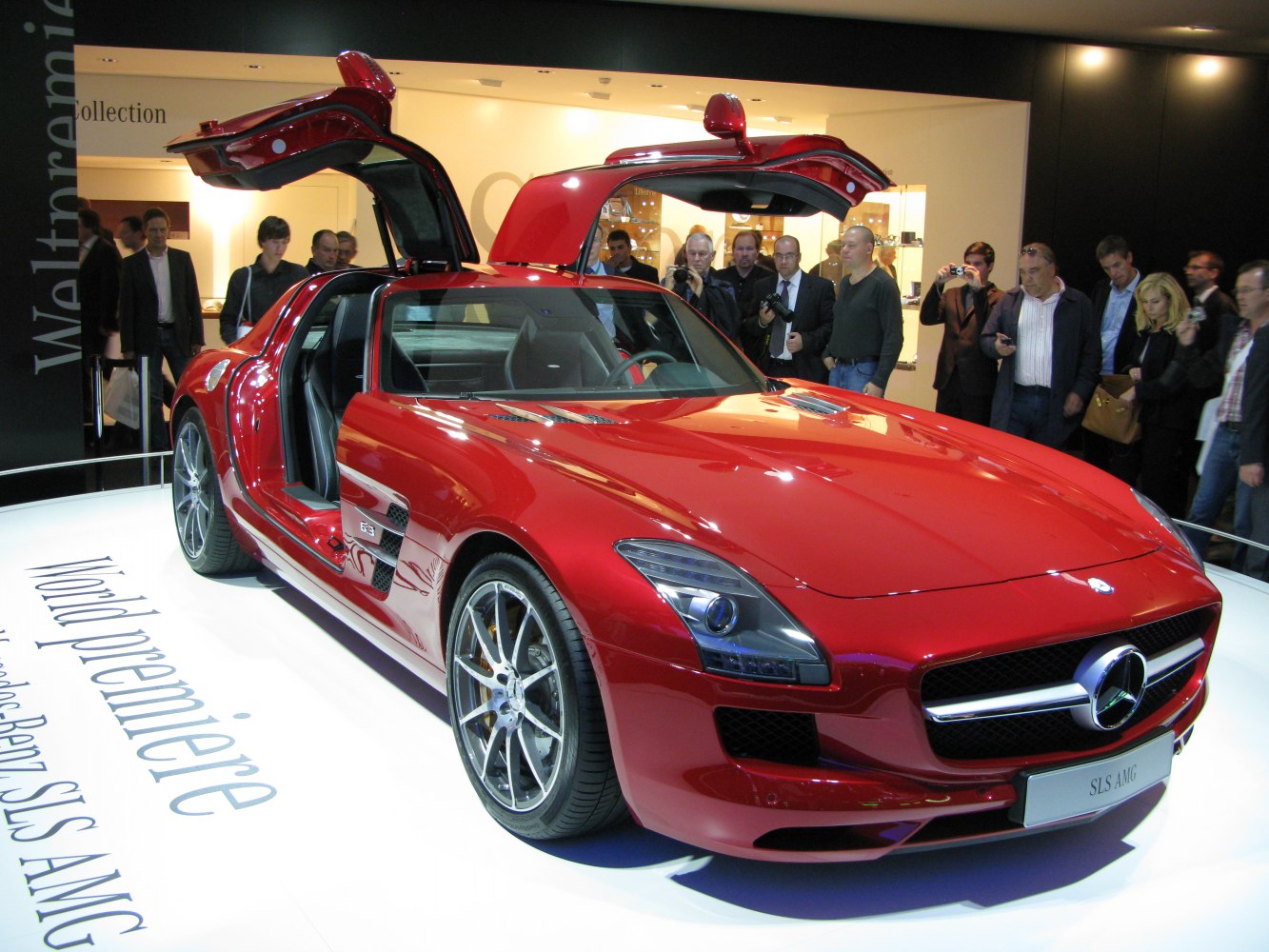 Red sports coupe with distinctive gullwing doors open