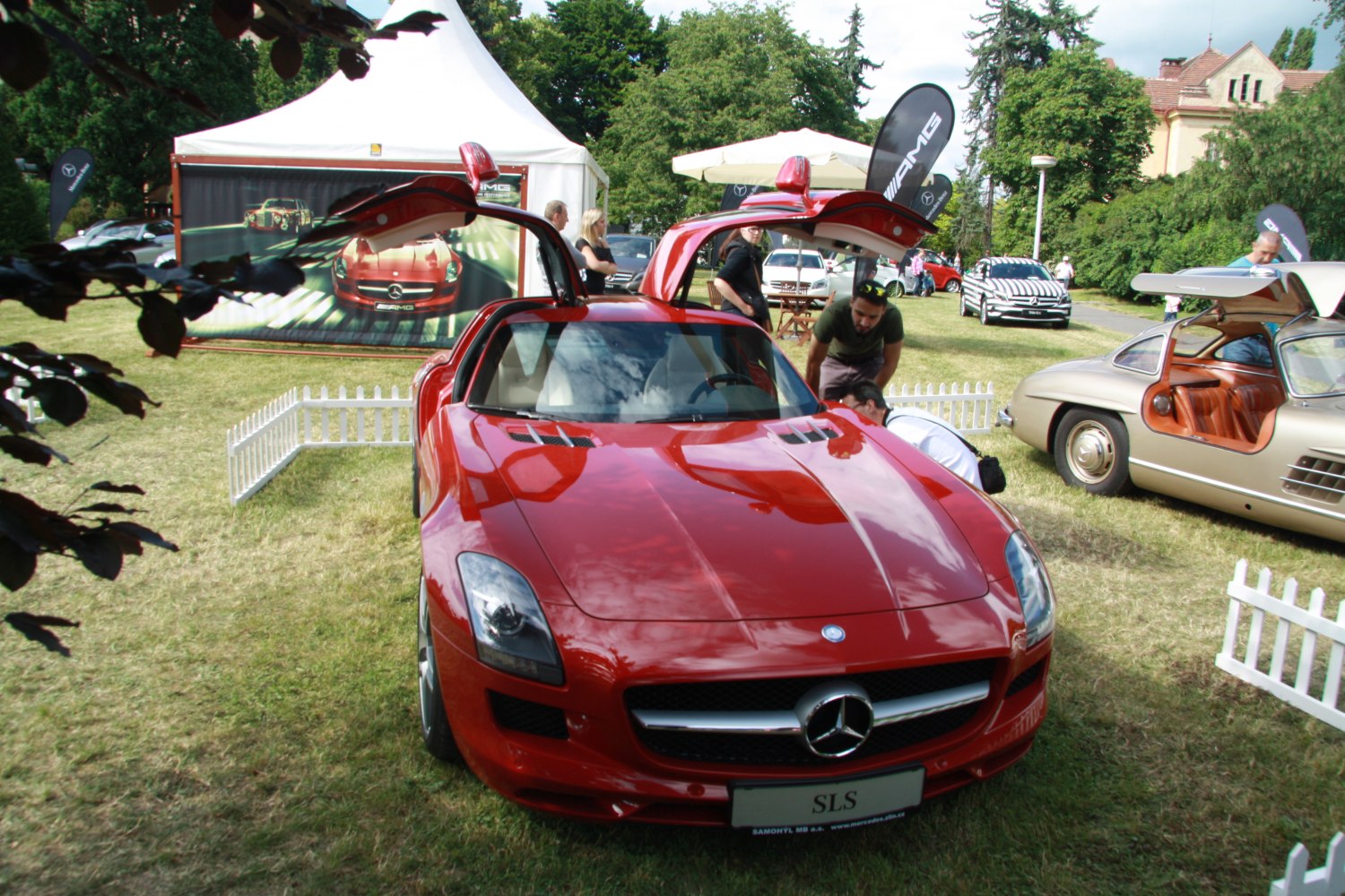 Red sports coupe with distinctive gullwing doors open