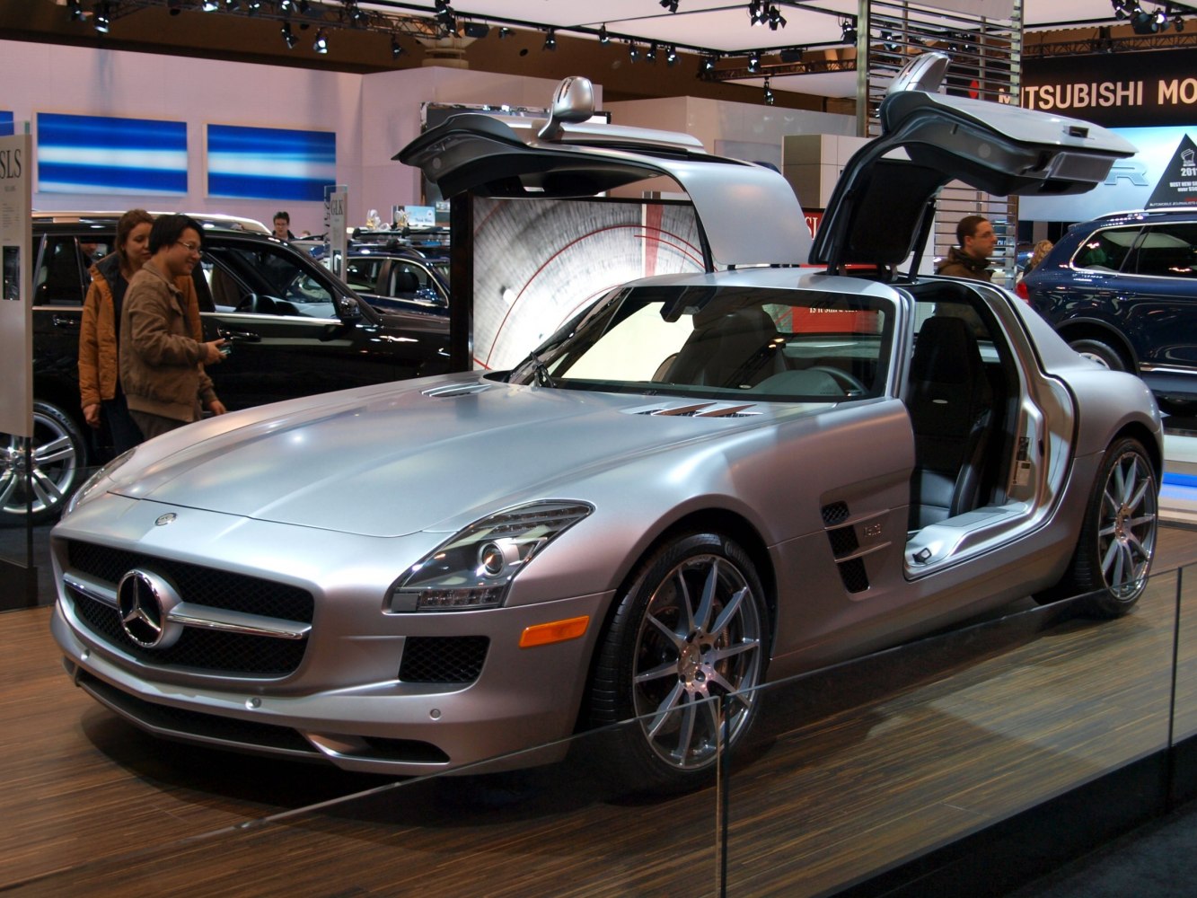 Silver sports coupe with iconic gullwing doors open
