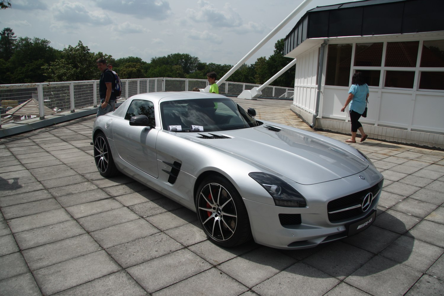 Silver luxury coupe with hood vents and sporty alloy wheels.