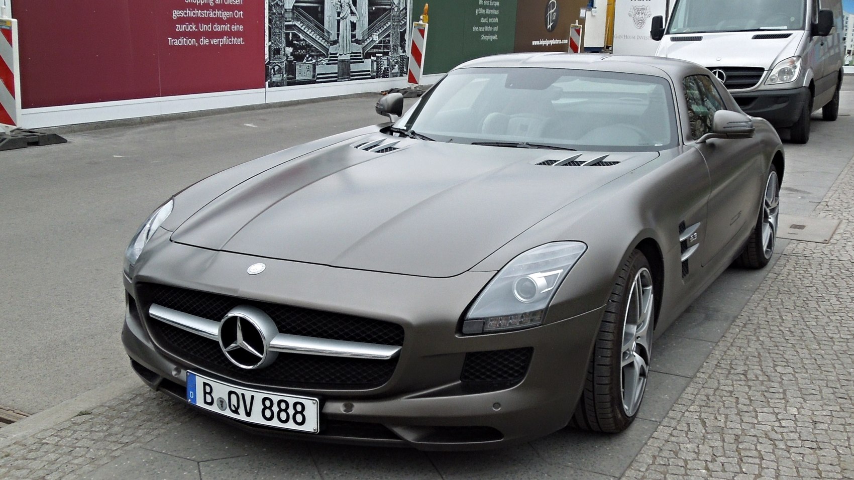 Front and side view of a sleek luxury sports coupe with distinctive grille and alloy wheels.