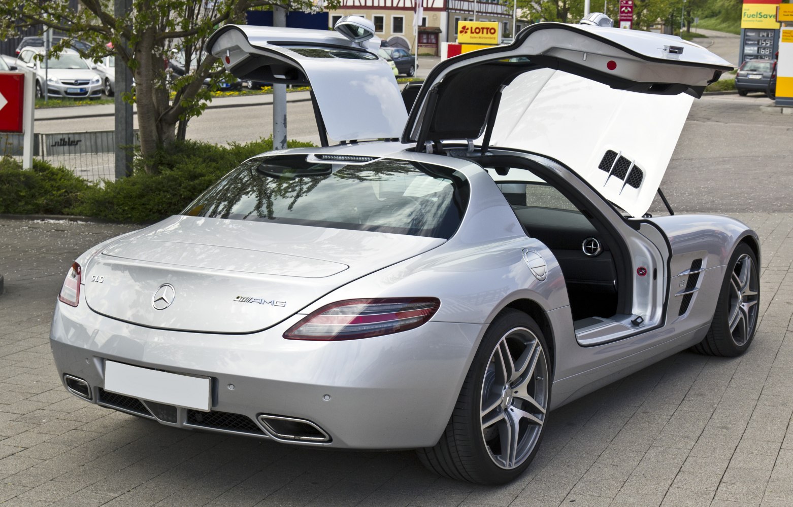 Silver sports coupe with iconic gullwing doors open