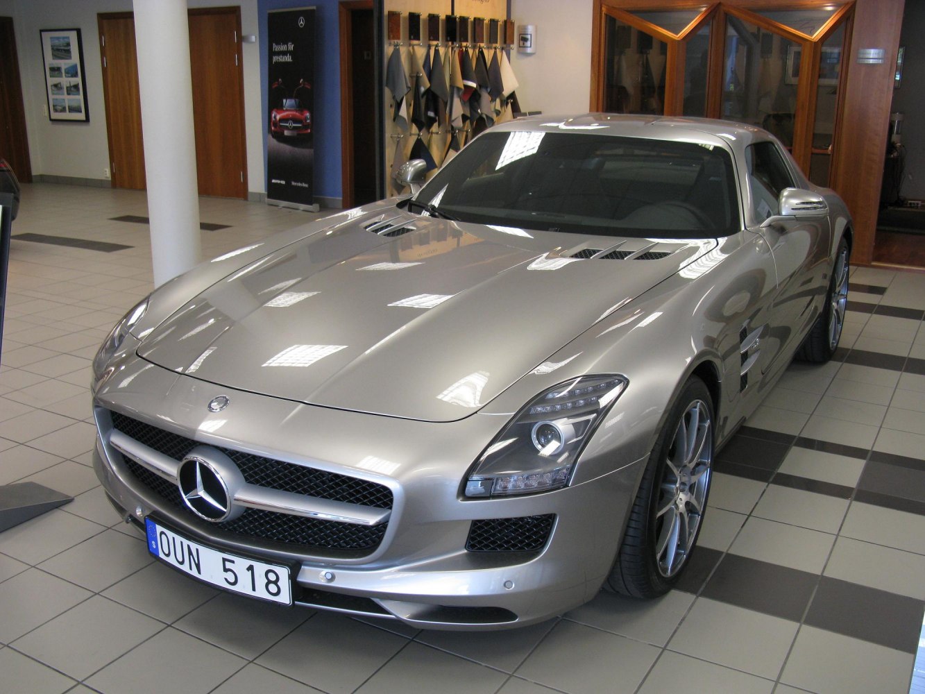 Front and side view of a sleek sports coupe with hood vents and alloy wheels