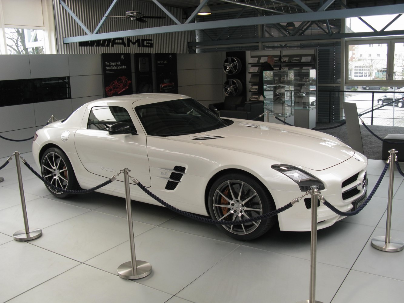 White sport coupe with aerodynamic vents and multi-spoke wheels