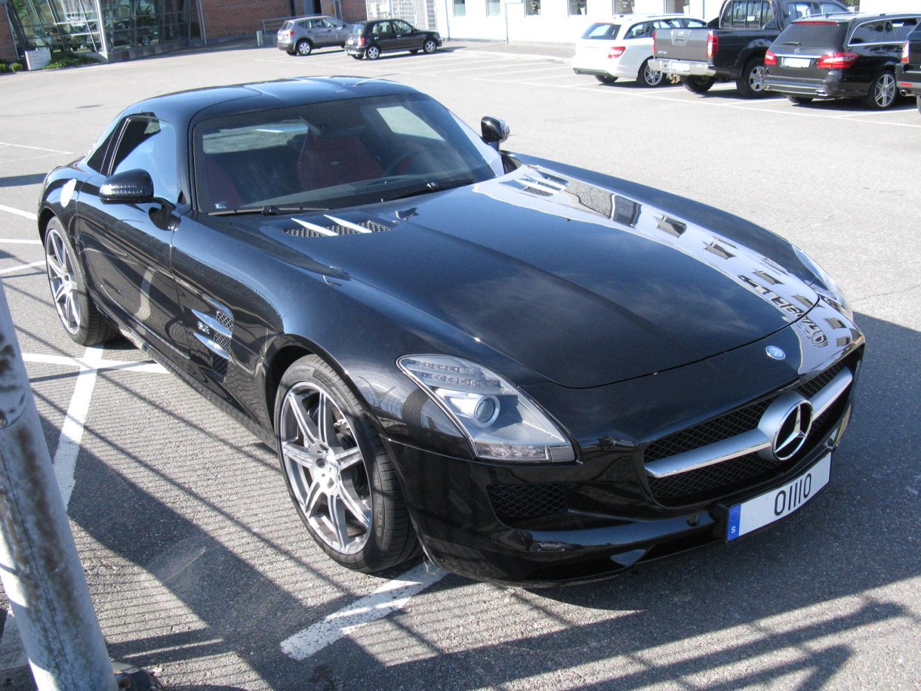 Black sports coupe with sporty front grille, vents, and aerodynamic hood.