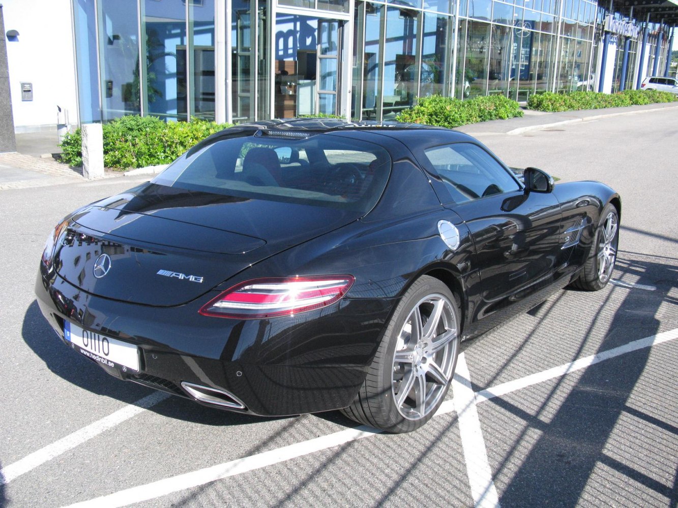 Rear view of black luxury coupe with AMG badge and sporty alloy wheels