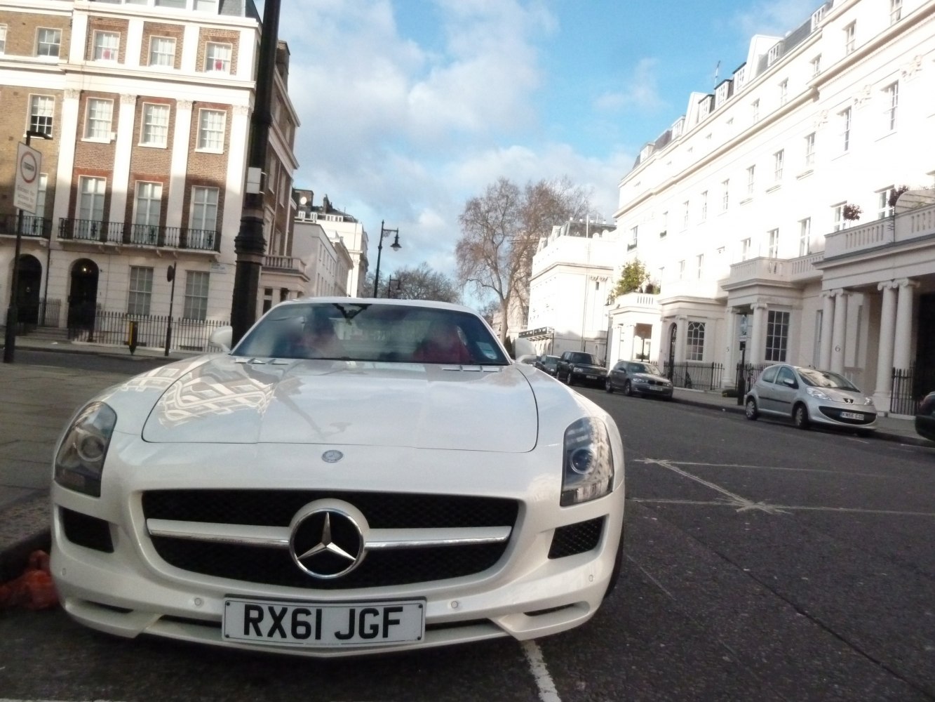 Close-up of front grille and headlights of a luxury sports coupe.