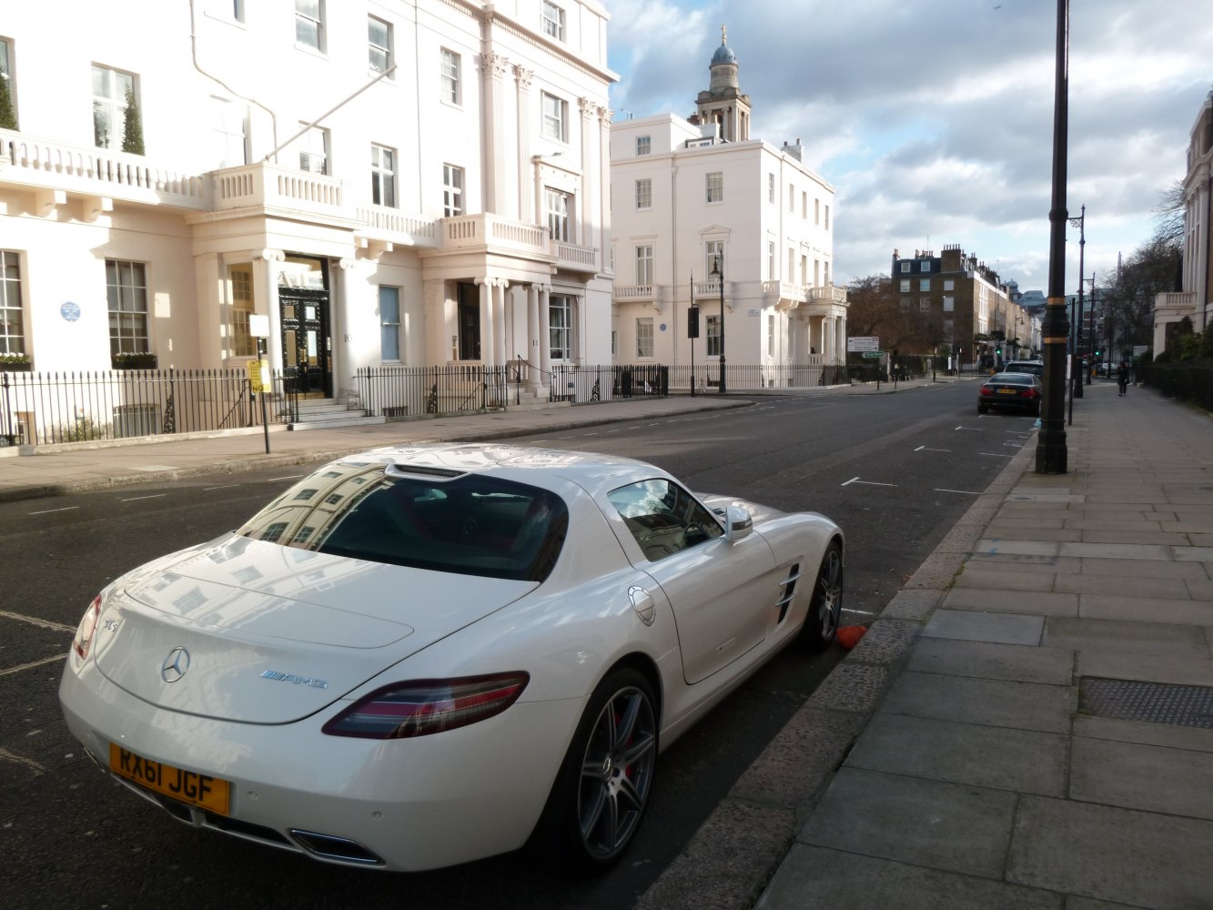 White sports coupe rear and side view with alloy wheels