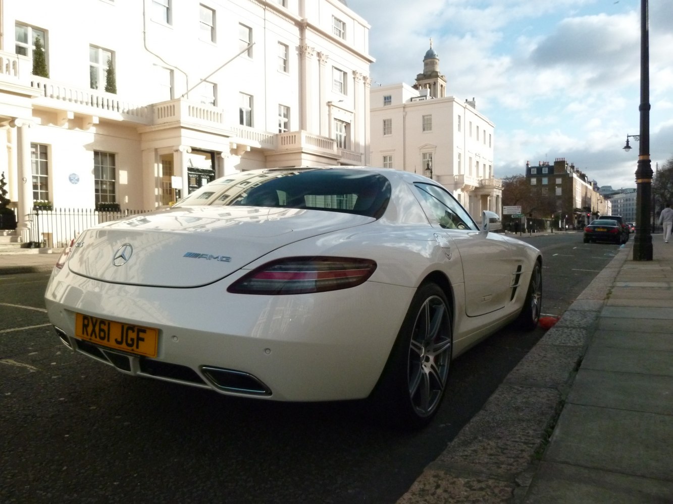 Rear side view of a white sports coupe with sleek taillights