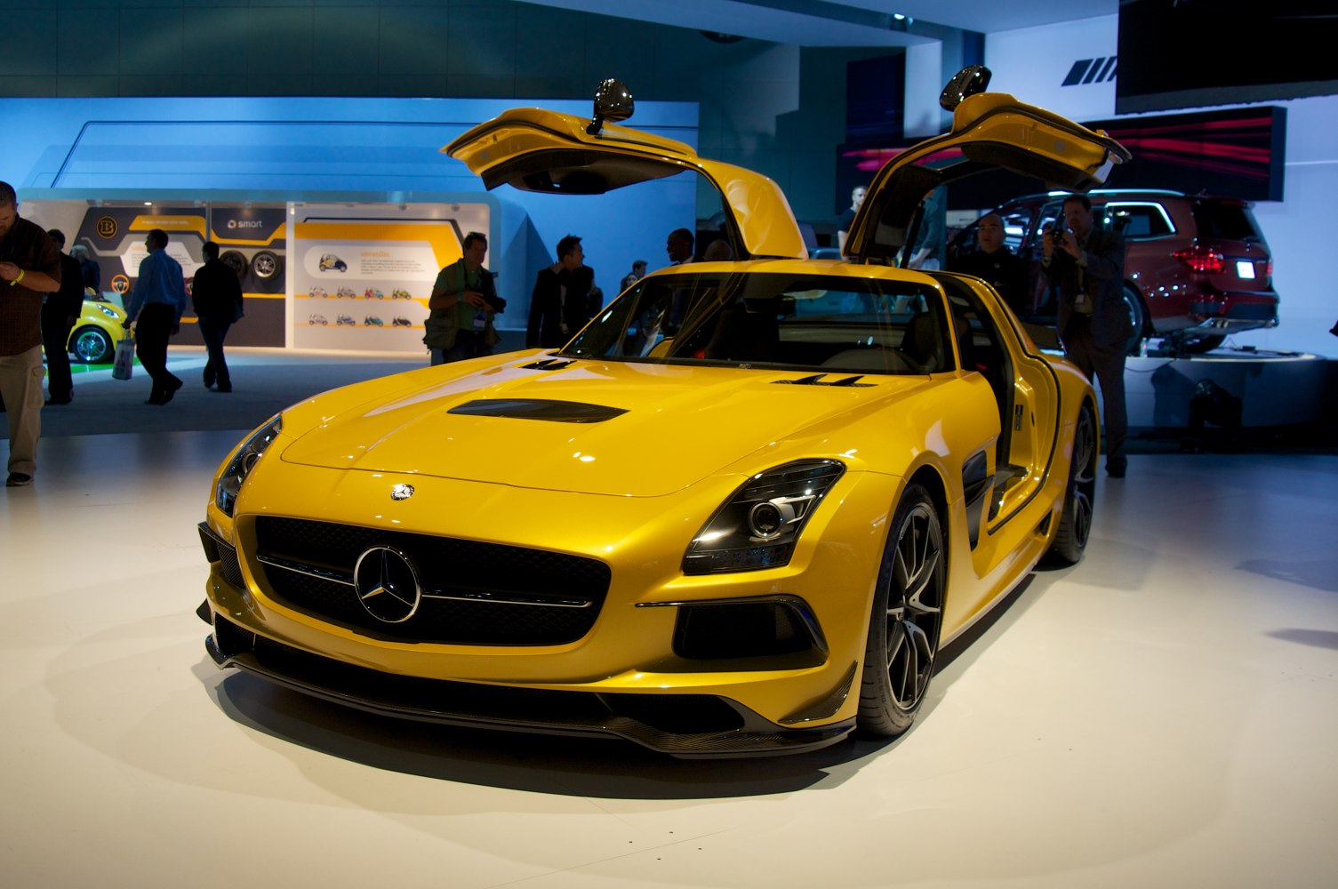 Yellow sports coupe with iconic gullwing doors open