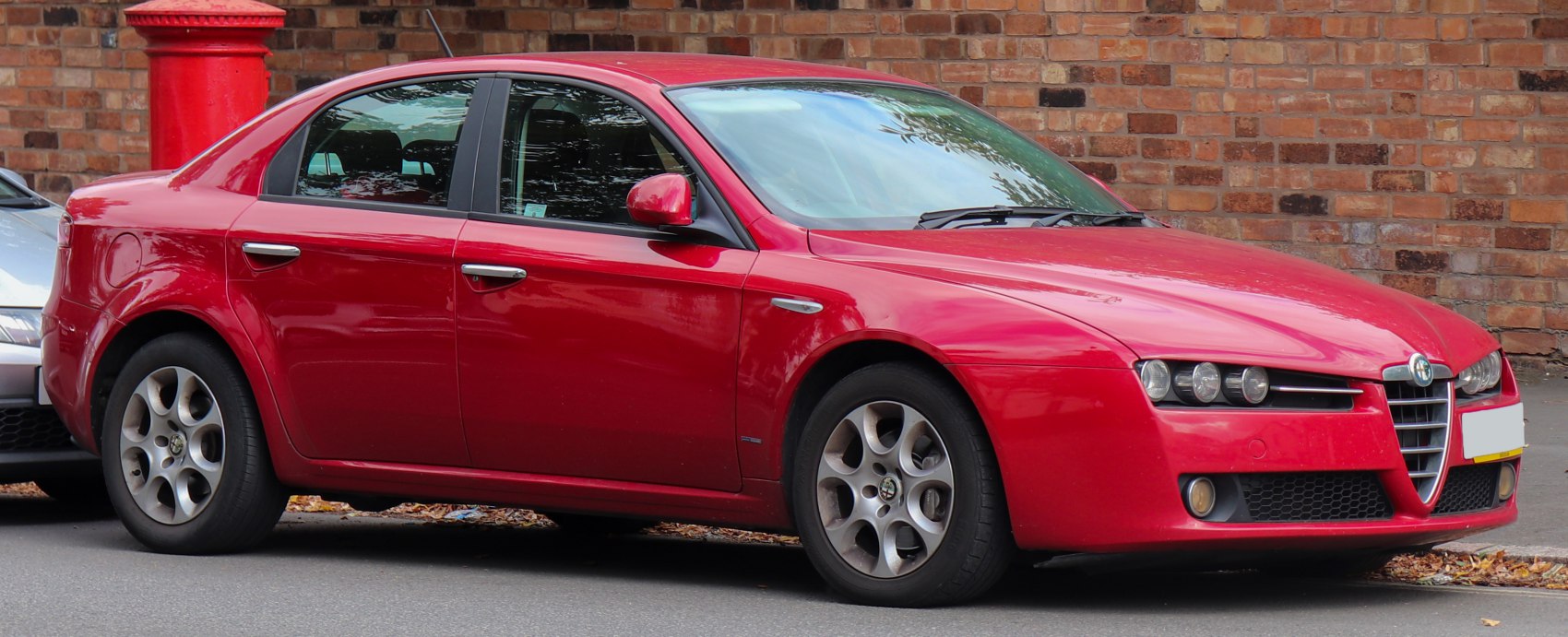 Red sedan with classic front grille and round headlights