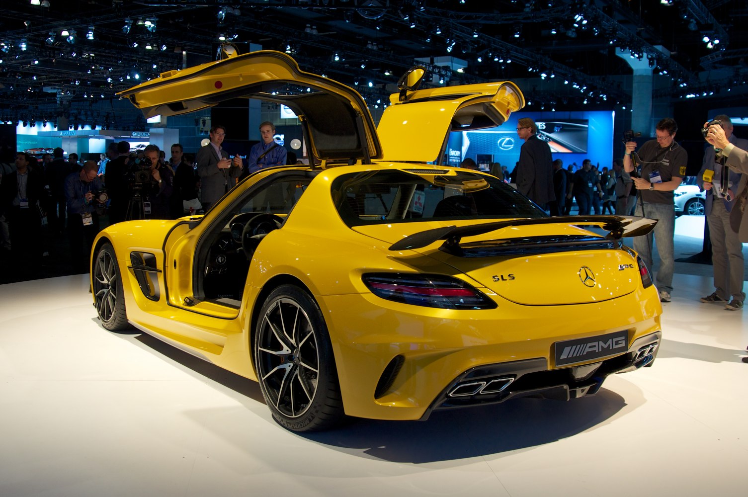 Yellow sports coupe with iconic gullwing doors and rear spoiler