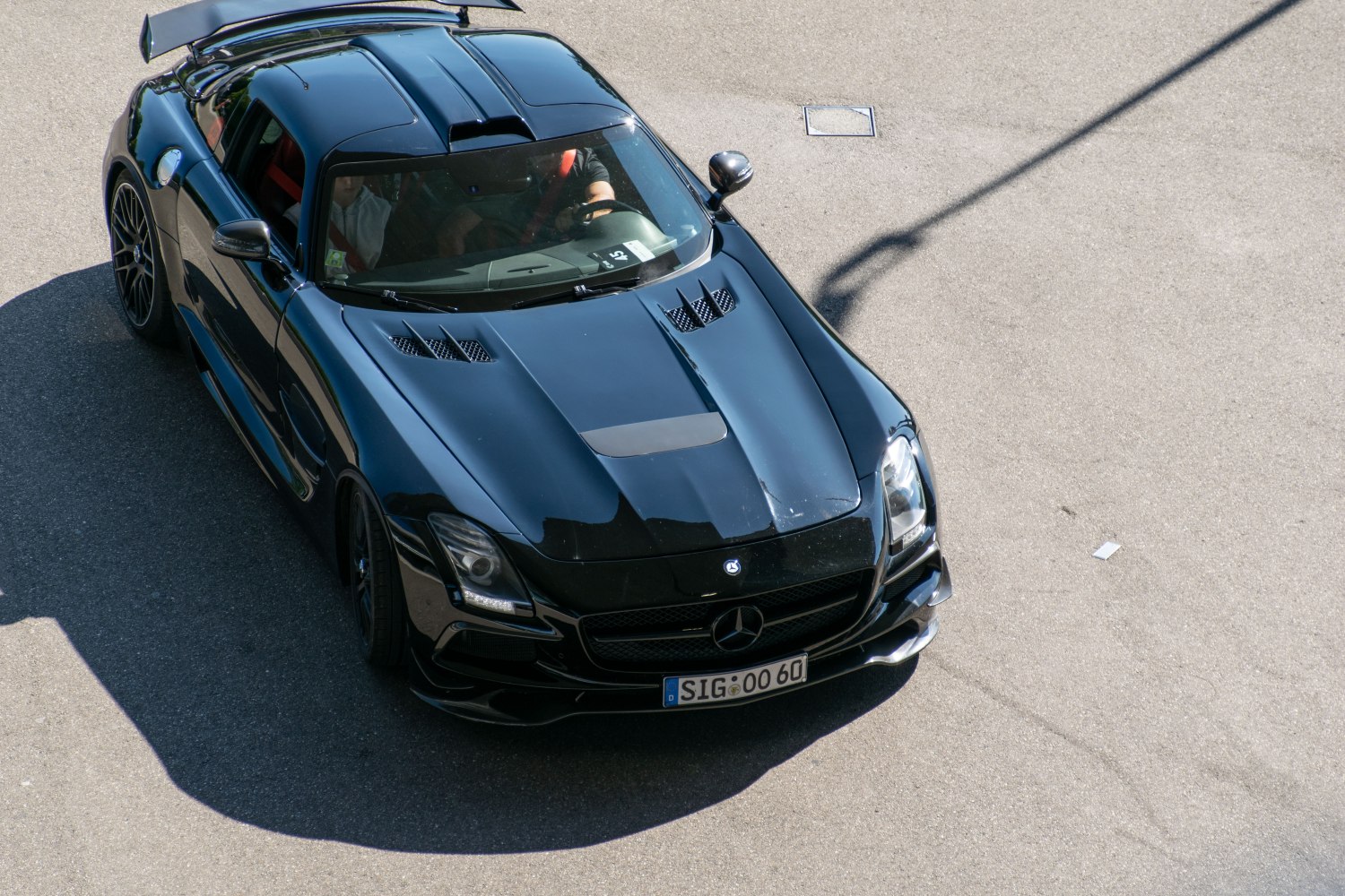 Black luxury coupe with aerodynamic hood vents and aggressive front design