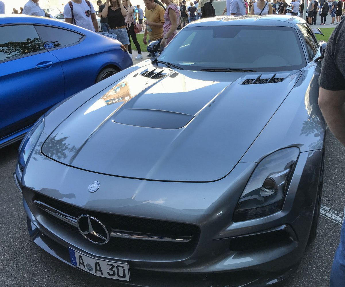 Front view of a silver sports coupe with vented hood and aerodynamic design