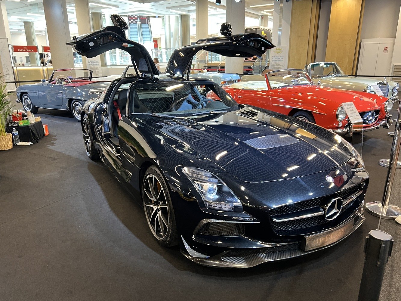 Black sports coupe with distinctive gullwing doors open