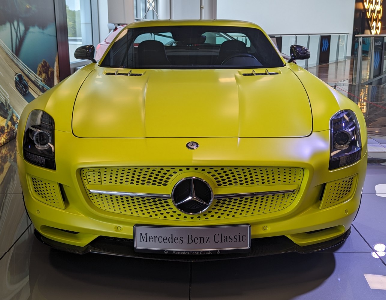 Front grille and headlights of yellow sports coupe