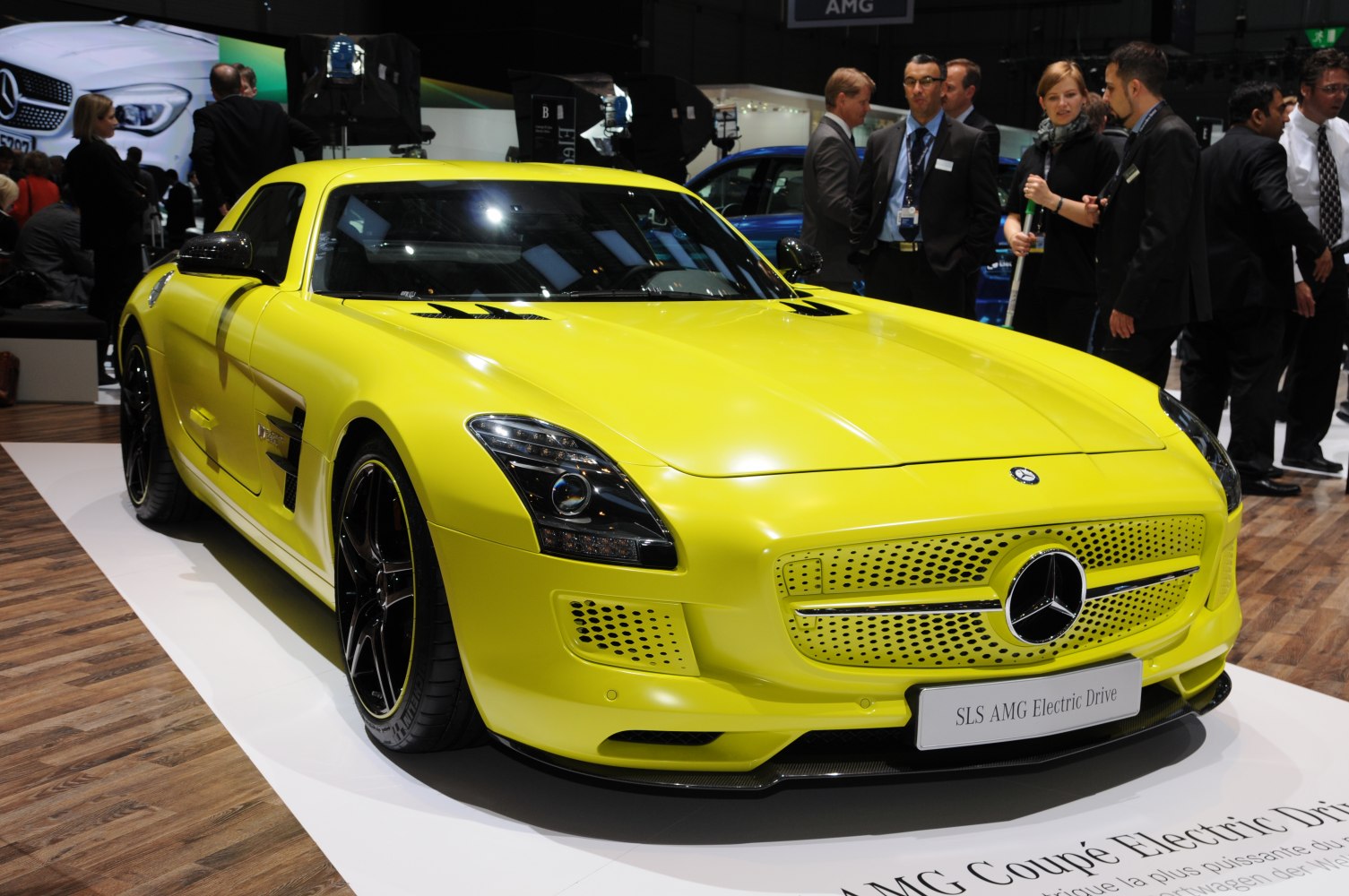 Aerodynamic yellow electric luxury sports coupe with AMG styling and black alloy wheels.