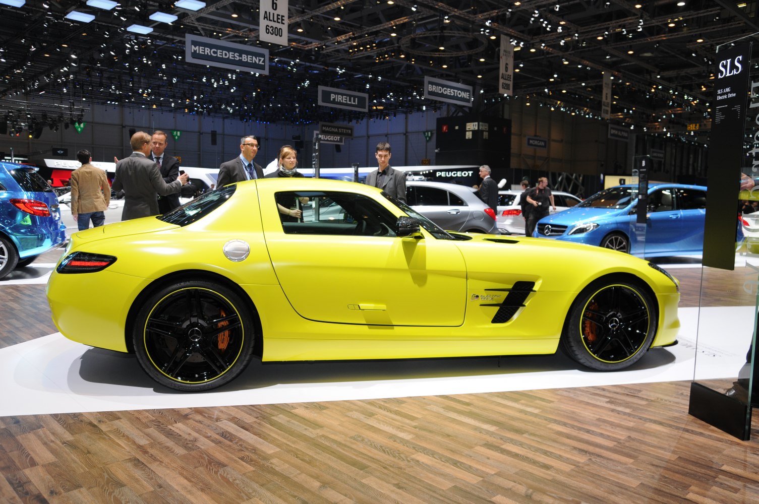 Sleek yellow sports coupe side view with black wheels and aerodynamic vents