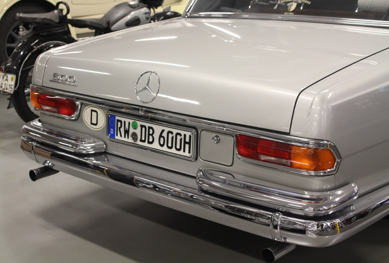 Rear detail of a classic luxury sedan with 600 emblem and chrome bumper.