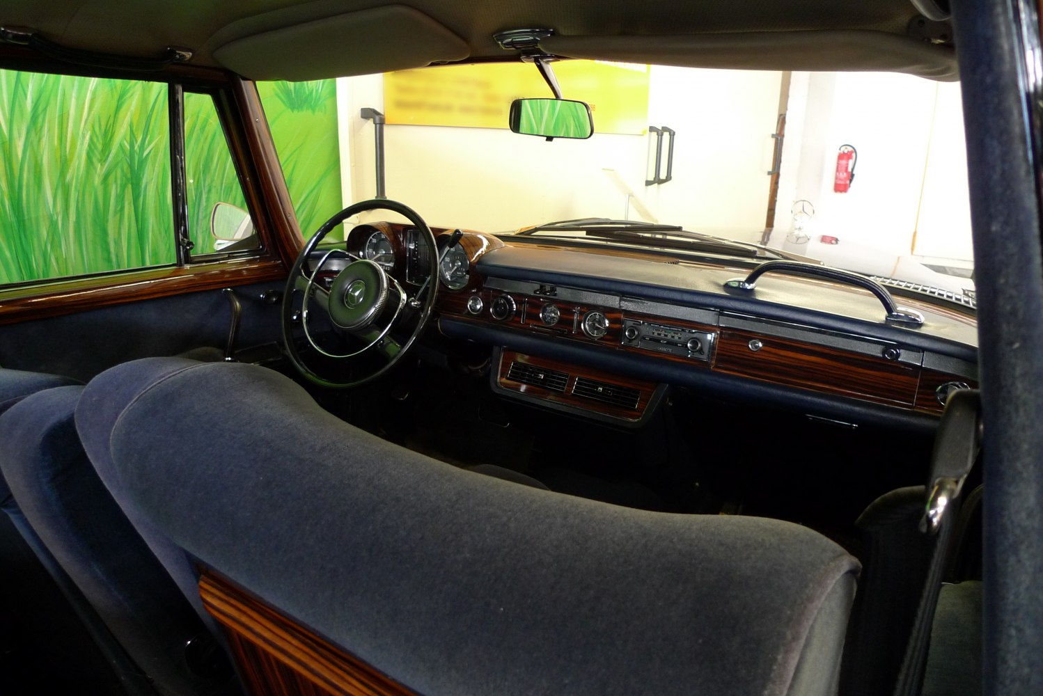 Vintage luxury car interior with wooden dashboard and fabric upholstery